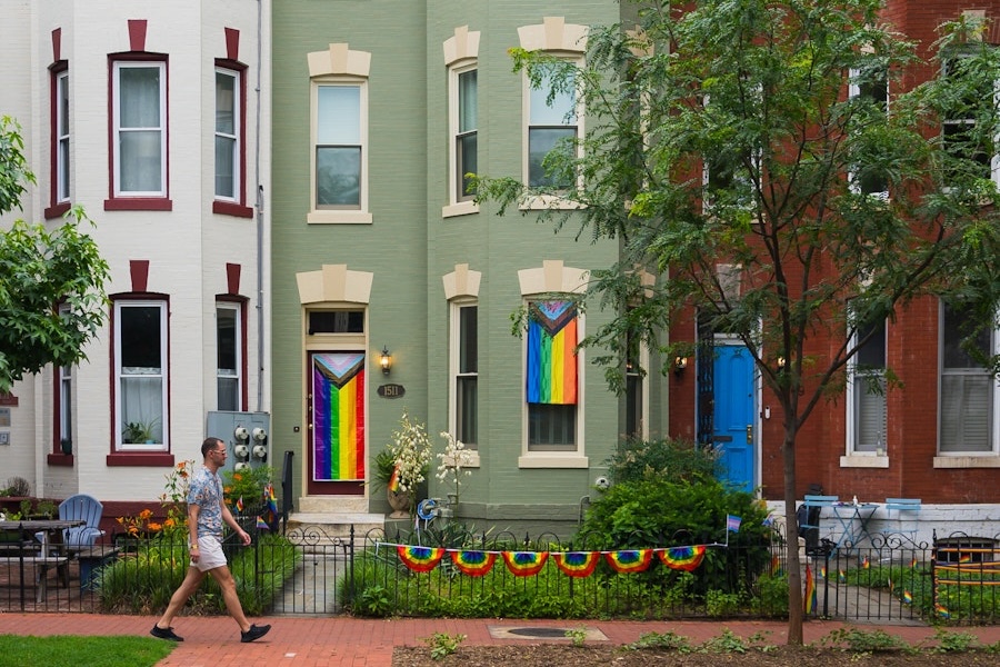 Capitol Hill rowhouses decorated with rainbow flags and banners.
