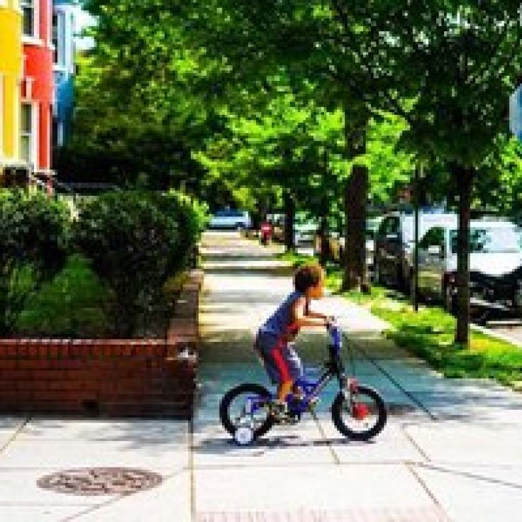 @maisiesview - Child riding bicycle in Adams Morgan neighborhood - Things to do in Washington, DC