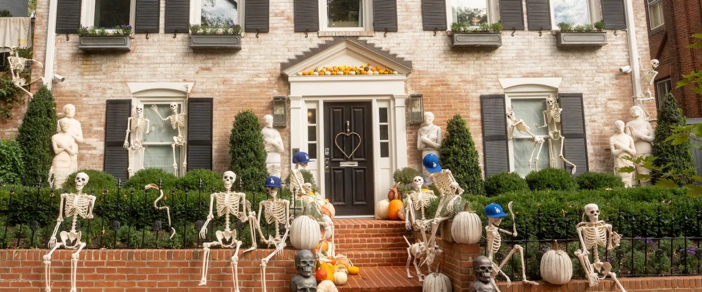 Skeletons and pumpkins decorate the front of a historic home in Georgetown.