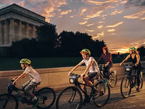 Family biking in front of Lincoln Memorial