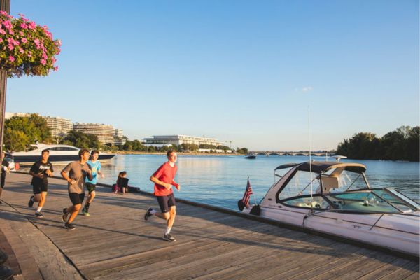 Group of people running beside Georgetown Waterfront