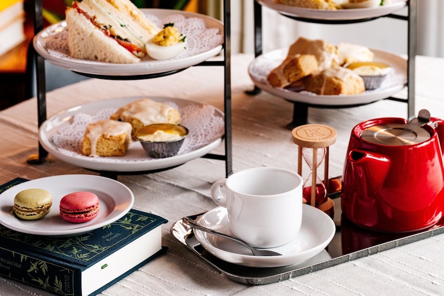 A high tea spread displayed beside a book.