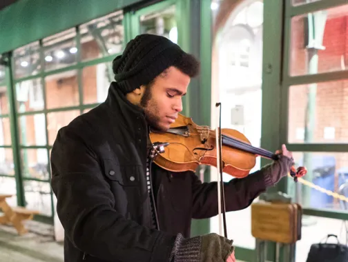 Man playing Violin in Cold Weather